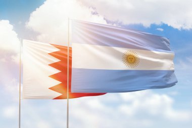 Sunny blue sky and flags of argentina and bahrain