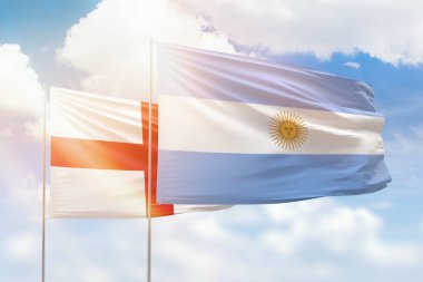 Sunny blue sky and flags of argentina and england