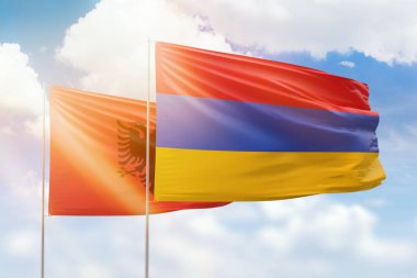 Sunny blue sky and flags of armenia and albania