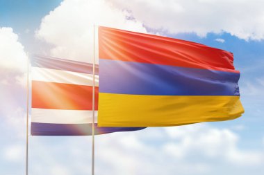 Sunny blue sky and flags of armenia and costa rica