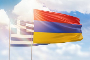 Sunny blue sky and flags of armenia and greece