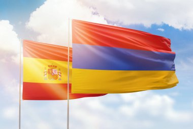 Sunny blue sky and flags of armenia and spain
