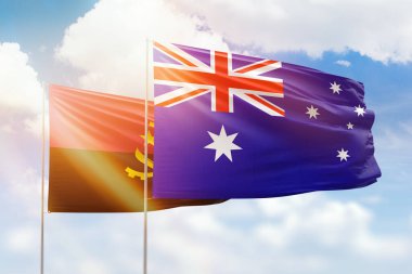 Sunny blue sky and flags of australia and angola