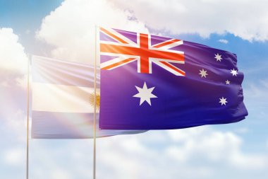 Sunny blue sky and flags of australia and argentina