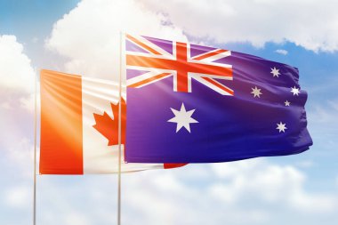 Sunny blue sky and flags of australia and canada