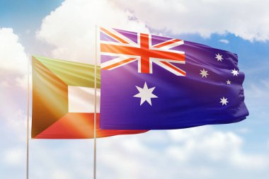 Sunny blue sky and flags of australia and kuwait