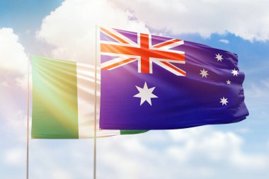 Sunny blue sky and flags of australia and nigeria