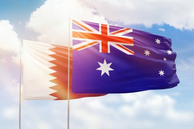 Sunny blue sky and flags of australia and qatar