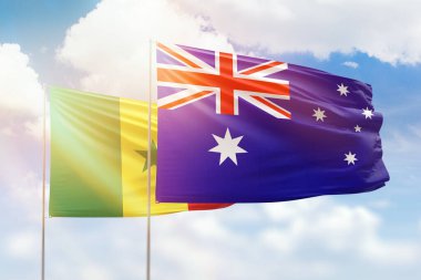 Sunny blue sky and flags of australia and senegal