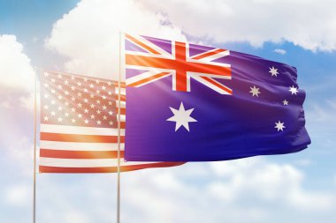 Sunny blue sky and flags of australia and usa
