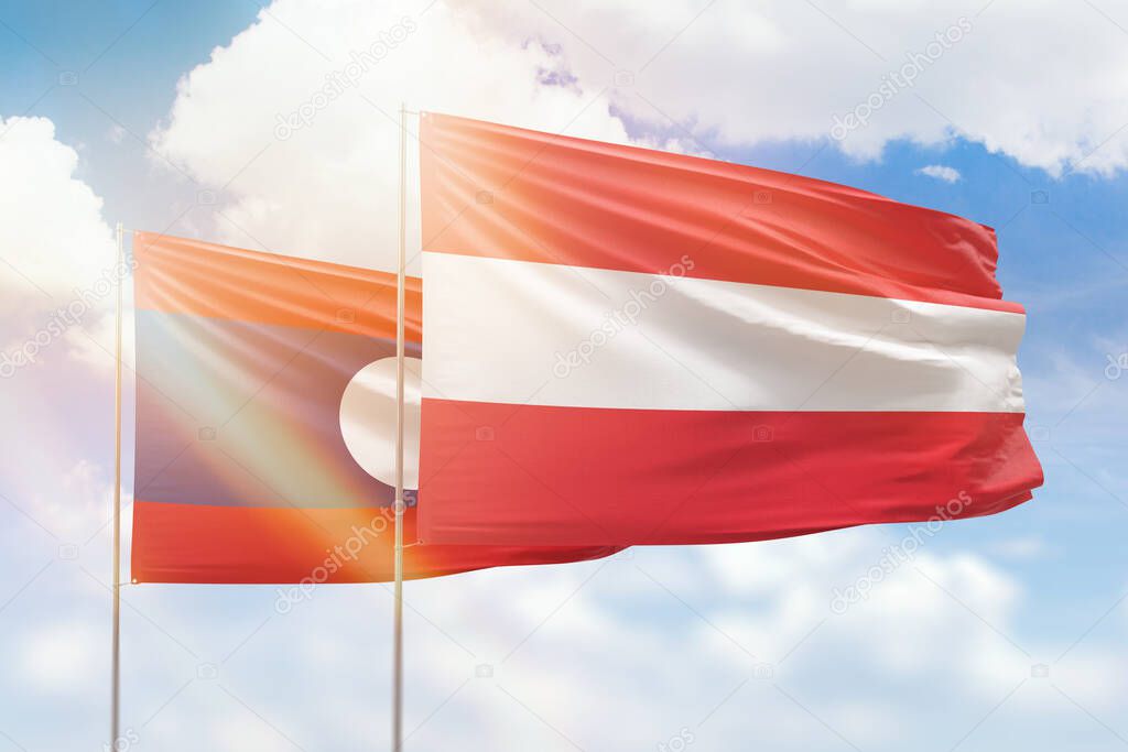 Sunny blue sky and flags of austria and laos