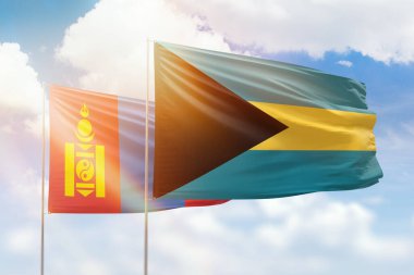 Sunny blue sky and flags of bahamas and mongolia