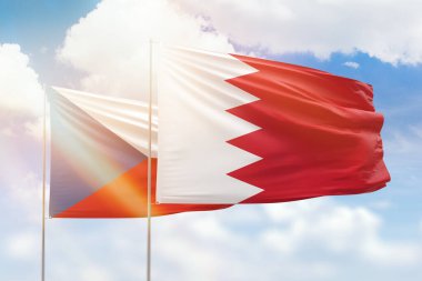 Sunny blue sky and flags of bahrain and czechia