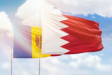 Sunny blue sky and flags of bahrain and moldova