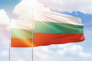 Sunny blue sky and flags of bulgaria and bulgaria