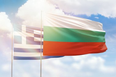 Sunny blue sky and flags of bulgaria and greece