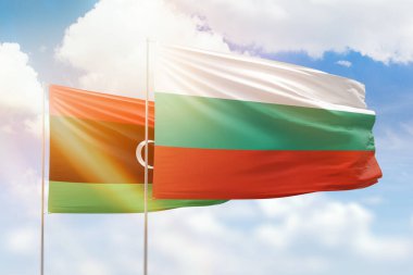 Sunny blue sky and flags of bulgaria and libya
