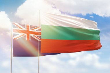 Sunny blue sky and flags of bulgaria and new zealand