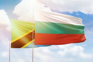 Sunny blue sky and flags of bulgaria and tanzania