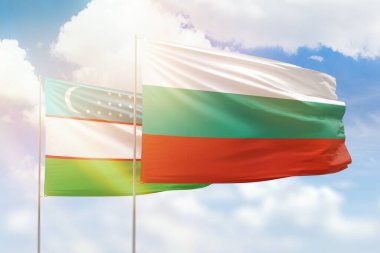 Sunny blue sky and flags of bulgaria and uzbekistan