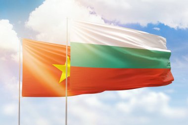 Sunny blue sky and flags of bulgaria and vietnam