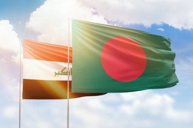 Sunny blue sky and flags of bangladesh and iraq