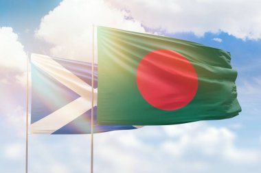 Sunny blue sky and flags of bangladesh and scotland
