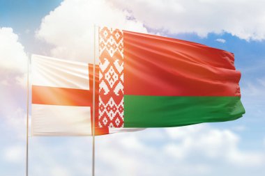 Sunny blue sky and flags of belarus and england