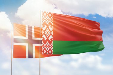 Sunny blue sky and flags of belarus and norway