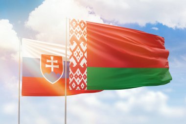 Sunny blue sky and flags of belarus and slovakia
