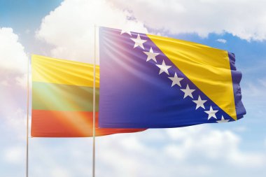 Sunny blue sky and flags of bosnia and lithuania