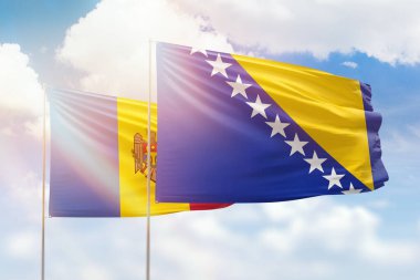 Sunny blue sky and flags of bosnia and moldova