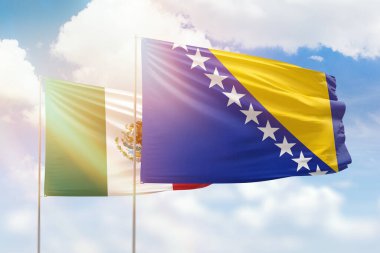 Sunny blue sky and flags of bosnia and mexico