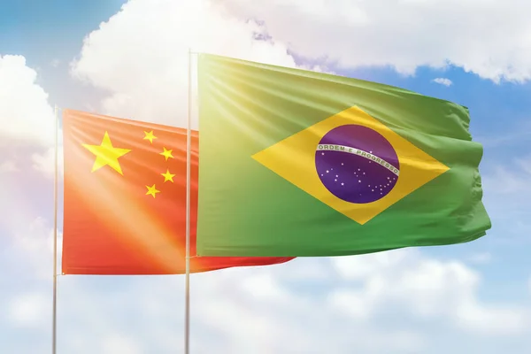 Sunny blue sky and flags of brazil and china