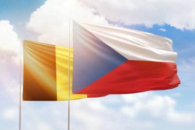 Sunny blue sky and flags of czechia and belgium