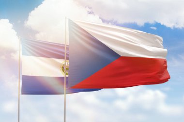 Sunny blue sky and flags of czechia and el salvador