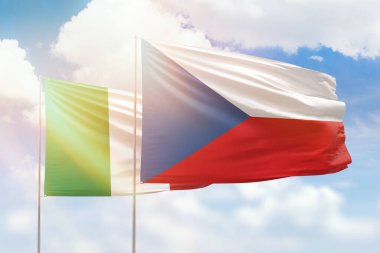 Sunny blue sky and flags of czechia and italy