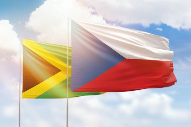 Sunny blue sky and flags of czechia and jamaica
