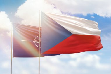 Sunny blue sky and flags of czechia and nato