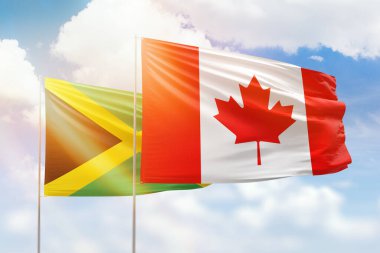 Sunny blue sky and flags of canada and jamaica