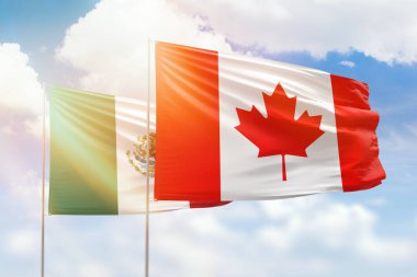 Sunny blue sky and flags of canada and mexico