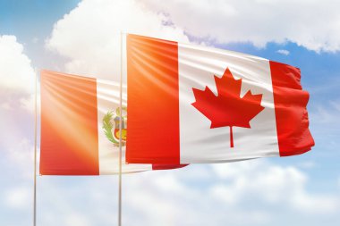 Sunny blue sky and flags of canada and peru