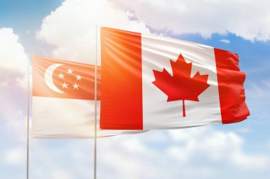 Sunny blue sky and flags of canada and singapore
