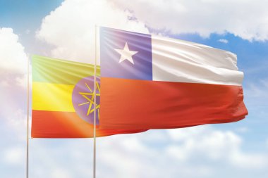 Sunny blue sky and flags of chile and ethiopia