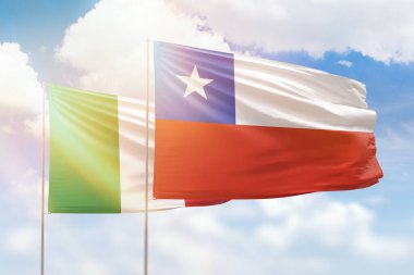 Sunny blue sky and flags of chile and italy
