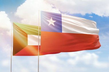 Sunny blue sky and flags of chile and kuwait