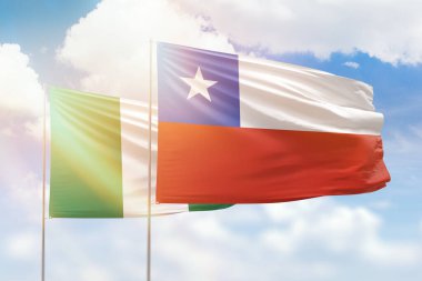 Sunny blue sky and flags of chile and nigeria