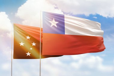 Sunny blue sky and flags of chile and papua new guinea