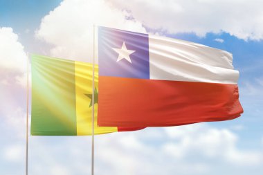 Sunny blue sky and flags of chile and senegal