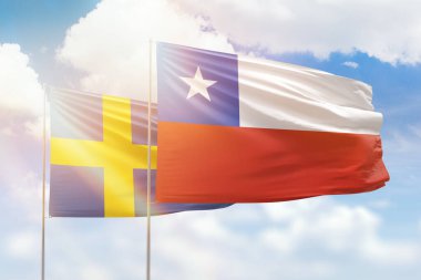 Sunny blue sky and flags of chile and sweden